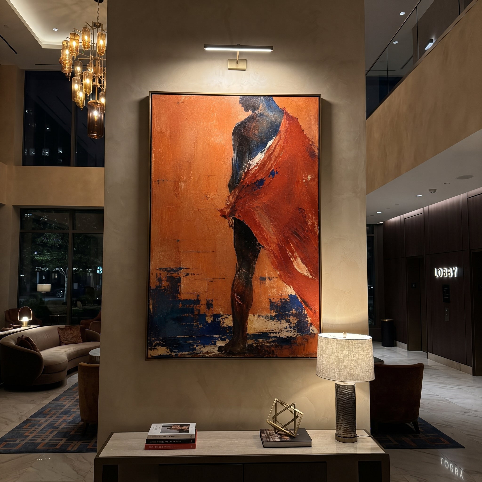 A red cloak whips across a dark body as if caught by wind from the sea. The spare orange field turns the figure into a traveler stepping through heat, pride, and danger.