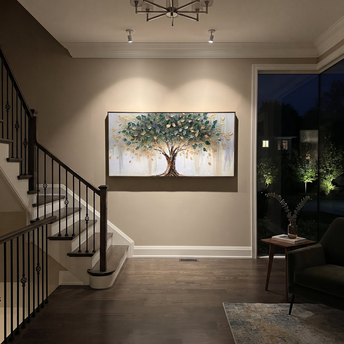 "Golden Leaf Tree Painting" focuses on atmosphere, surface movement, and sculptural heavy impasto craftsmanship rather than a fixed literal storyline. The composition uses this hand-painted panoramic canvas presents a centered tree with sweeping branches, deep green foliage, metallic golden leaves, a bright white-grey background, and sculpted impasto texture that gives the leaves a dimensional handmade surface as the visual anchor, while layered palette-knife paint, raised plaster-like texture