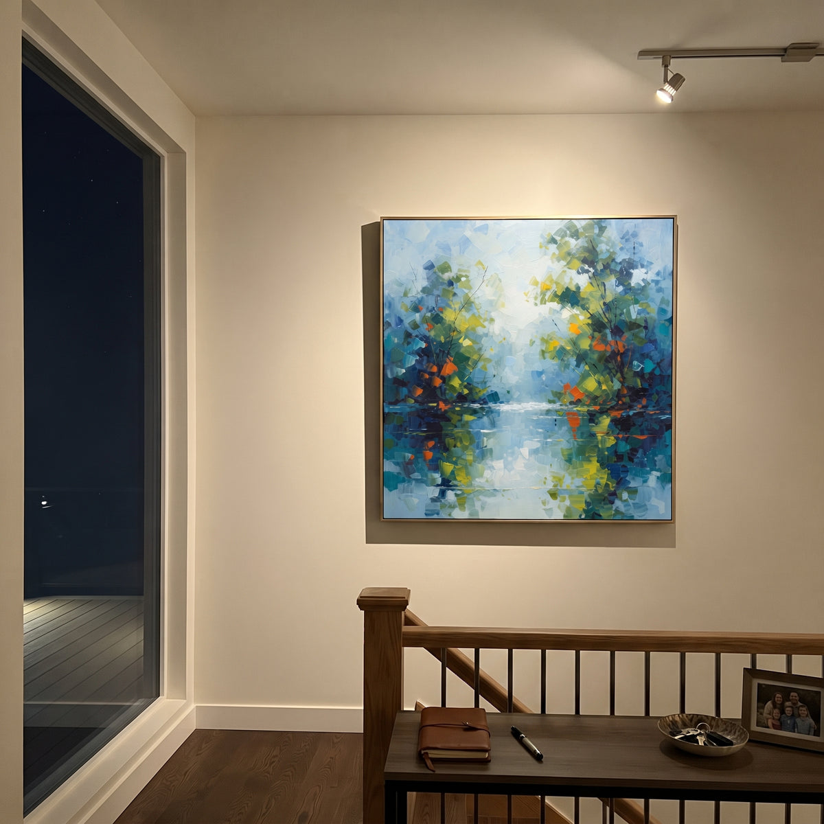 "Blue Green Lake Reflection Painting" focuses on atmosphere, surface movement, and sculptural heavy impasto craftsmanship rather than a fixed literal storyline. The composition uses this hand-painted square canvas presents a calm blue green waterside forest with reflected foliage, pale sky light, orange leaf accents, and layered impasto brushwork as the visual anchor, while layered palette-knife paint, raised plaster-like texture, and softened brush movement create tactile depth across the