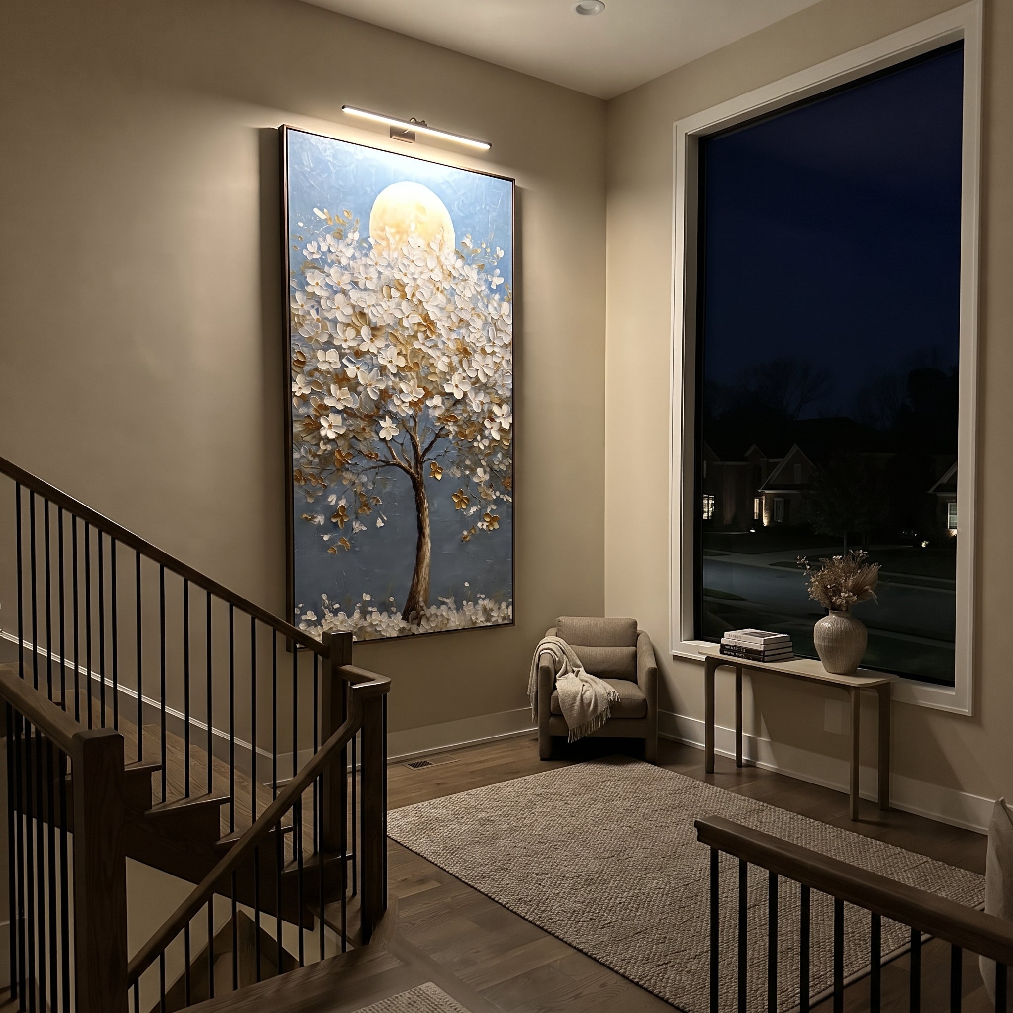 "Moonlit White Blossom Tree Painting" focuses on atmosphere, surface movement, and sculptural heavy impasto craftsmanship rather than a fixed literal storyline. The composition uses this hand-painted vertical canvas presents a tall tree covered in raised white blossoms and golden leaves, set before a soft round moon on a clear blue background as the visual anchor, while layered palette-knife paint, raised plaster-like texture, and softened brush movement create tactile depth across the canvas.
