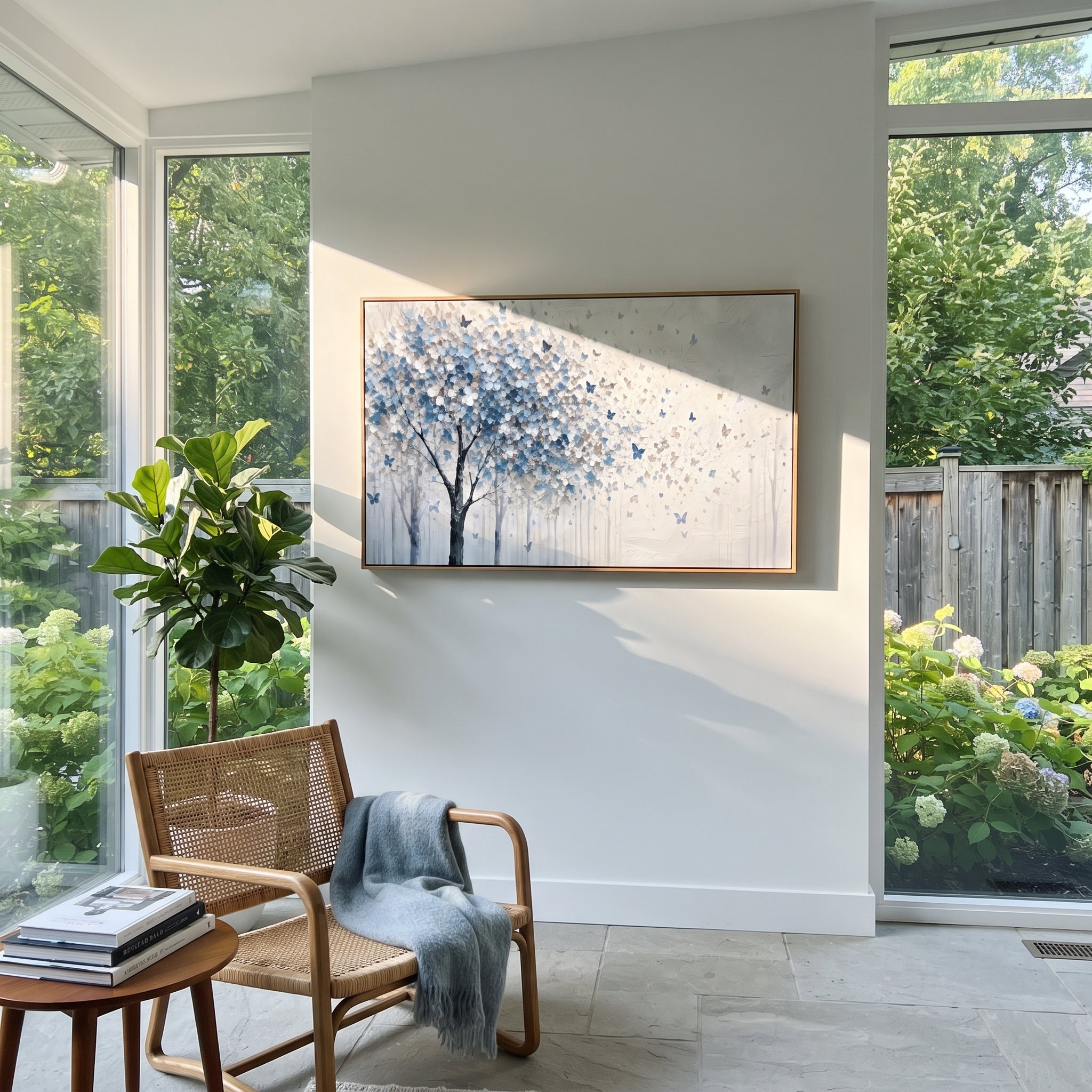 "Blue Butterfly Tree Painting" focuses on atmosphere, surface movement, and sculptural heavy impasto craftsmanship rather than a fixed literal storyline. The composition uses this hand-painted panoramic canvas presents a blue grey and white blossoming tree on the left with small blue butterflies drifting into an open white textured field as the visual anchor, while layered palette-knife paint, raised plaster-like texture, and softened brush movement create tactile depth across the canvas.