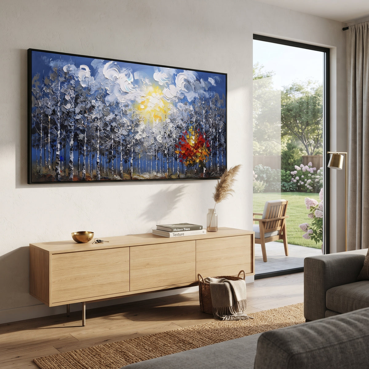 "Blue Forest Sunburst Painting" focuses on atmosphere, surface movement, and sculptural heavy impasto craftsmanship rather than a fixed literal storyline. The composition uses this hand-painted panoramic canvas features a blue birch forest under swirling white clouds and a yellow sun, with one red orange autumn tree glowing against cool grey textured woods as the visual anchor, while layered palette-knife paint, raised plaster-like texture, and softened brush movement create tactile depth across