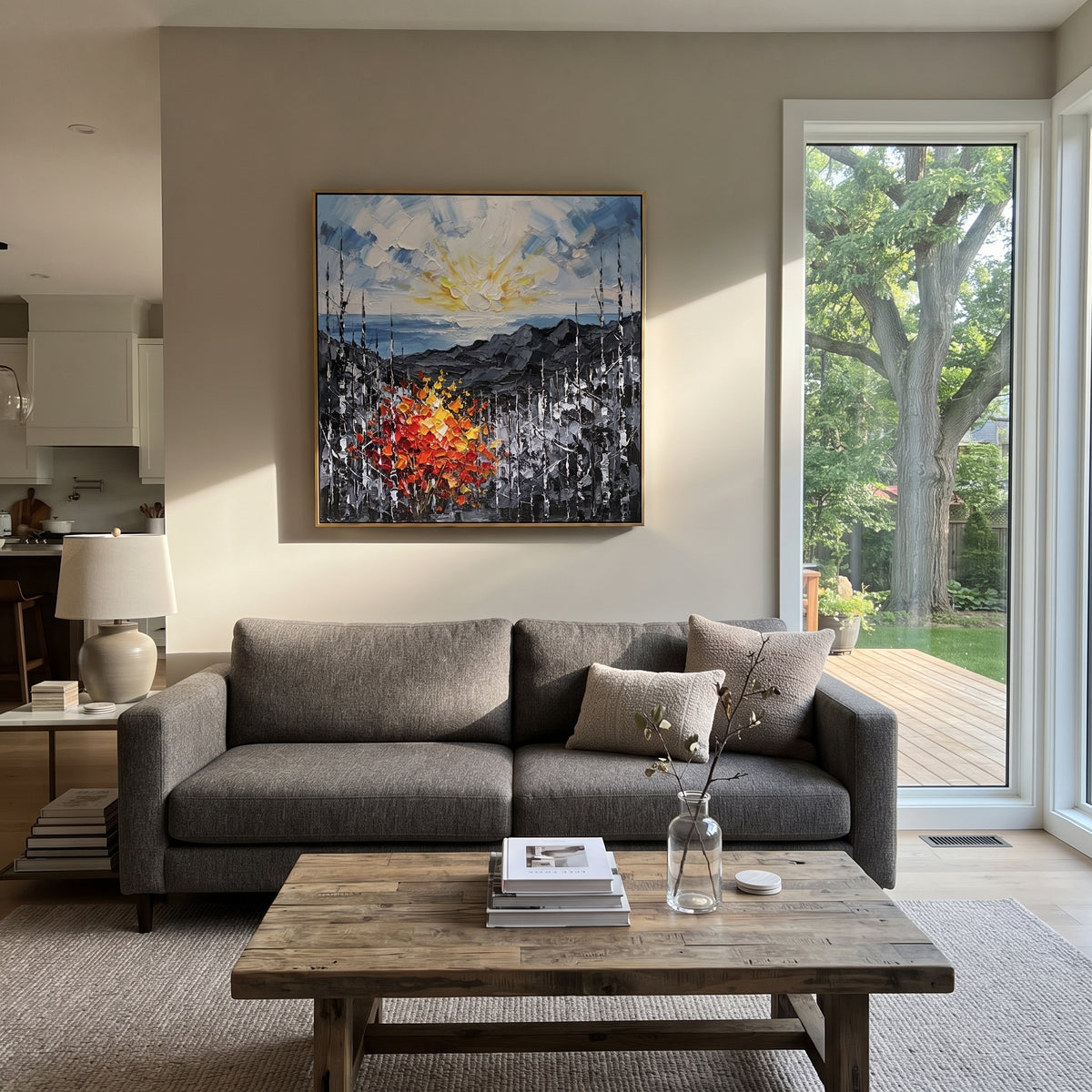 "Sunrise Ridge Birch Painting" focuses on atmosphere, surface movement, and sculptural heavy impasto craftsmanship rather than a fixed literal storyline. The composition uses this hand-painted square canvas presents a glowing sunrise over grey mountain ridges, with black and white birches and a red orange yellow autumn shrub in heavy textured strokes as the visual anchor, while layered palette-knife paint, raised plaster-like texture, and softened brush movement create tactile depth across the