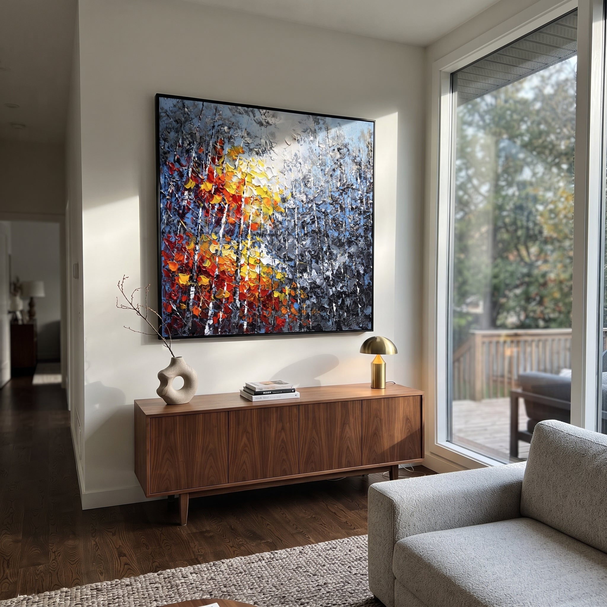"Blue Grey Autumn Birch Painting" focuses on atmosphere, surface movement, and sculptural heavy impasto craftsmanship rather than a fixed literal storyline. The composition uses this hand-painted square canvas presents layered blue grey woodland, slender white birches, and a close foreground burst of red, orange, yellow, and white leaves in thick impasto texture as the visual anchor, while layered palette-knife paint, raised plaster-like texture, and softened brush movement create tactile depth