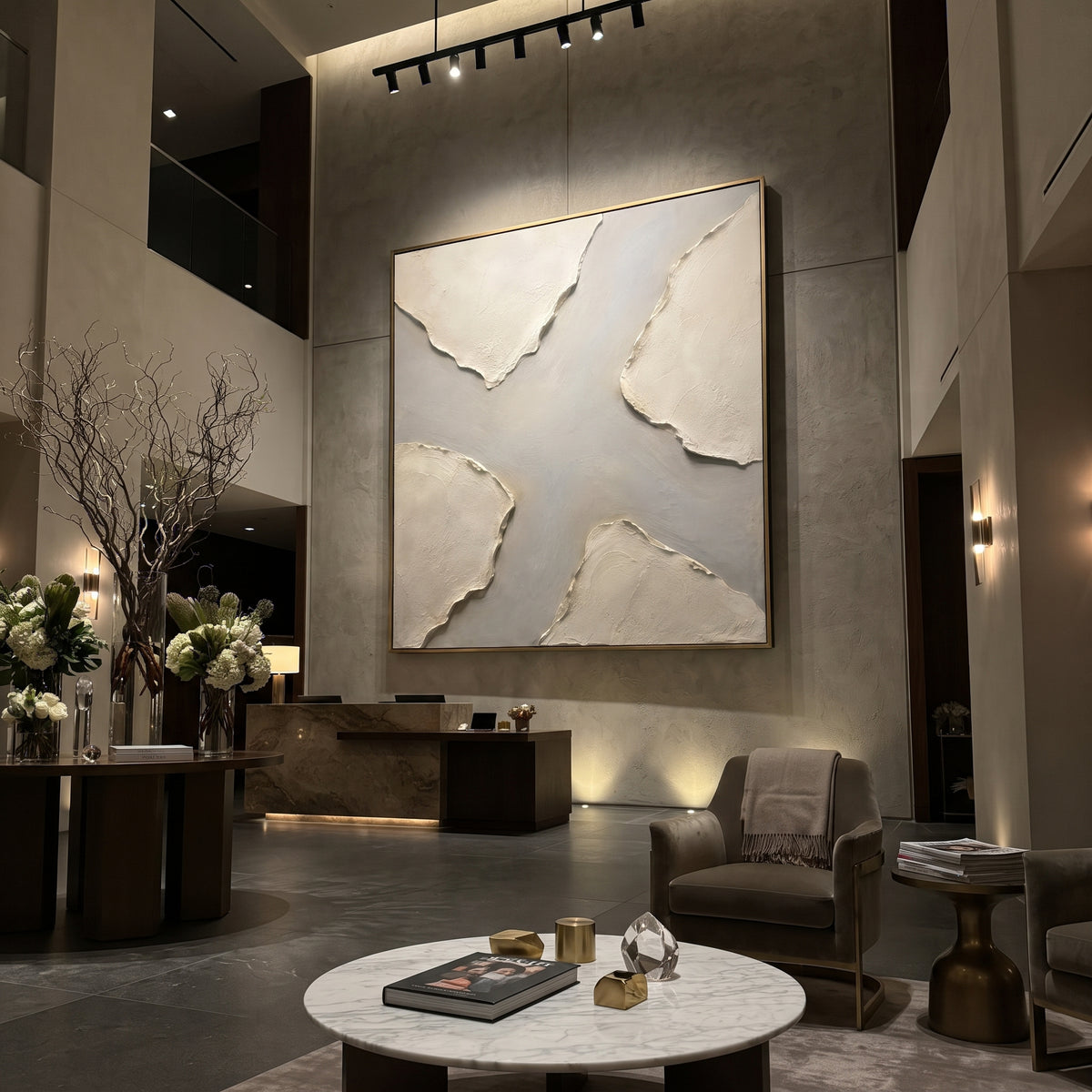 This neutral layered plaster relief painting uses torn-edge ivory forms, a soft grey center, and raised handmade texture as its visual anchor. The square composition keeps the abstract surface balanced while the beige, white, and grey palette gives modern interiors a quiet sculptural focal point.