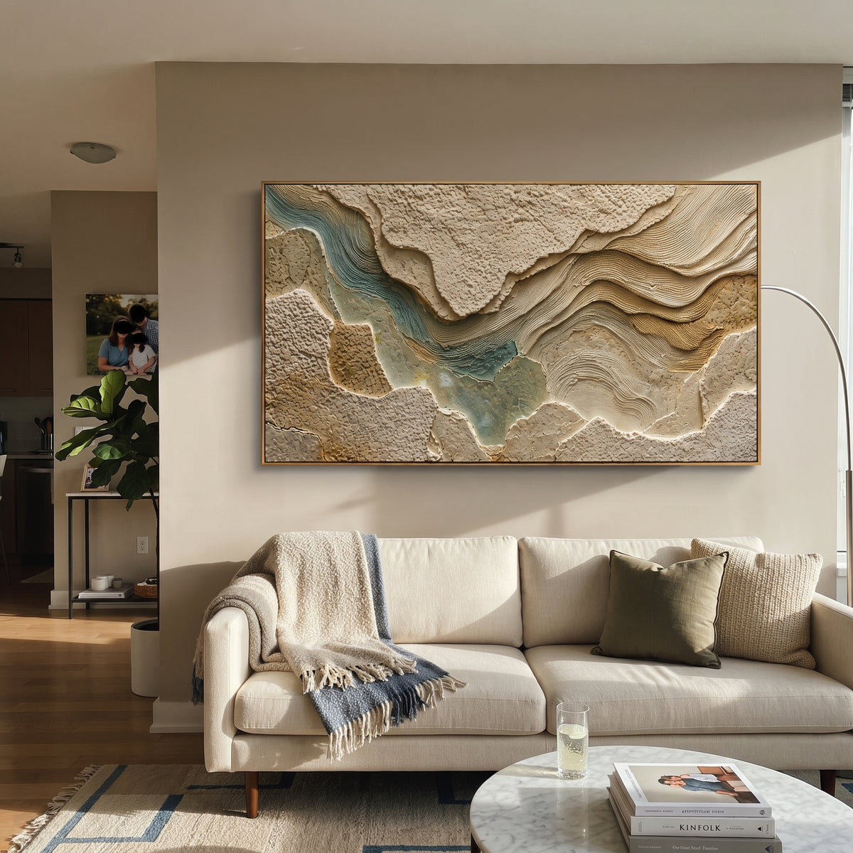 This topographic plaster relief painting uses raised earth-toned plates, carved contour lines, and muted teal passages to suggest a terrain map or river valley. Its panoramic format gives the sculptural abstract surface a wide architectural presence.