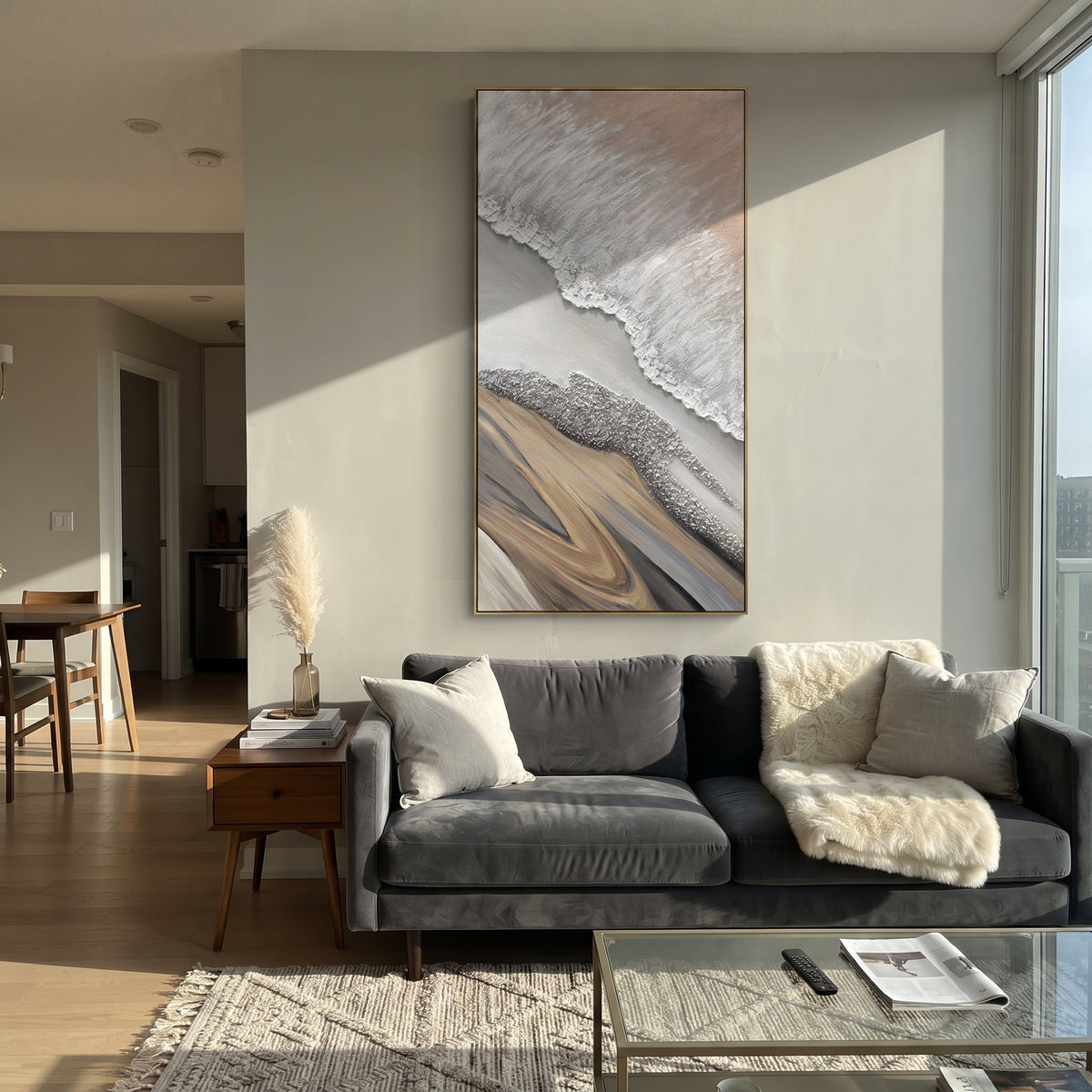 This abstract shoreline relief painting uses white raised ridges, grey passages, and sandy beige forms to suggest a quiet coast from above. The vertical format and tactile plaster surface make the piece calm, natural, and architectural.