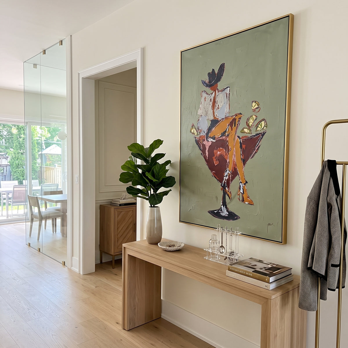 Cowboy Martini Chair focuses on a western figure sitting in a martini-shaped chair with bold red and gold accents, using the sage green family as the main atmosphere while keeping the subject and composition specific to the actual main image. The visible details are described from the artwork itself: the placement of the main forms, the surrounding negative space, the relationship between pale highlights and deeper green or dark accents, and the direction of the brushwork across the surface.
