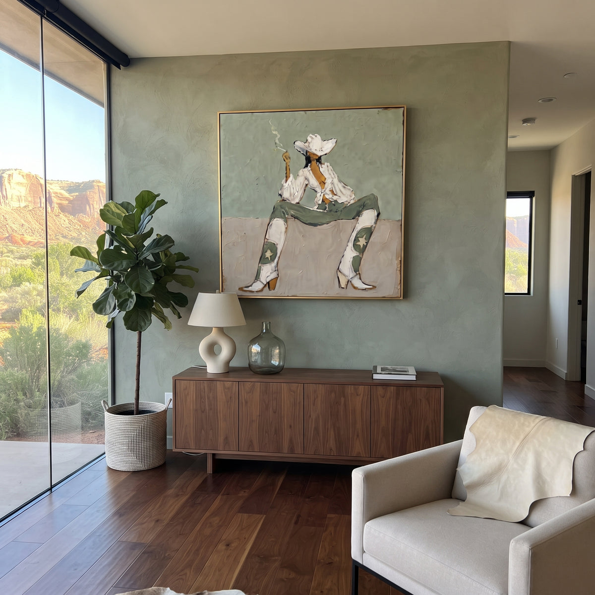 Seated Cowboy Sage Figure focuses on a seated cowboy figure in a wide white hat against muted sage and beige blocks, using the sage green family as the main atmosphere while keeping the subject and composition specific to the actual main image. The visible details are described from the artwork itself: the placement of the main forms, the surrounding negative space, the relationship between pale highlights and deeper green or dark accents, and the direction of the brushwork across the surface.