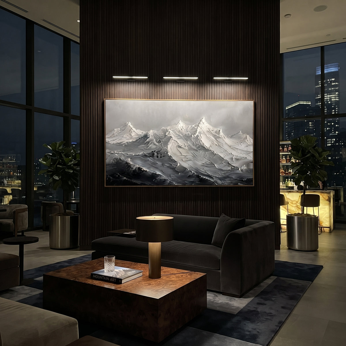 Storm Blue Glacier Peaks is written from the actual artwork image, focusing on storm blue glacier peaks with dark valley shadows and broken snowy ridges. The visible composition is specific rather than generic: blue-black lower valleys, broken ice-like ridges, and a pale storm sky over the mountain chain. The wide horizontal layout controls how the eye travels through the scene, with the mountain mass, valley floor, tree line, water edge, or small figure details arranged to create depth across