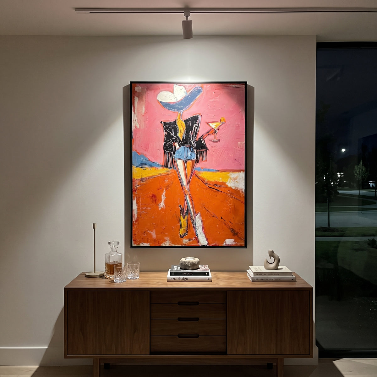 One Boot Martini Cowgirl is written from the actual artwork image, focusing on a standing cowgirl with one boot forward, black jacket, martini, and orange road. The composition is built from specific visible details: black jacket, long legs, one boot emphasis, martini glass, pink sky, and orange road. The vertical composition keeps attention on black jacket, long legs, one boot emphasis, martini glass, pink sky, and orange road, using open ground, cropped edges, and strong color blocks to make