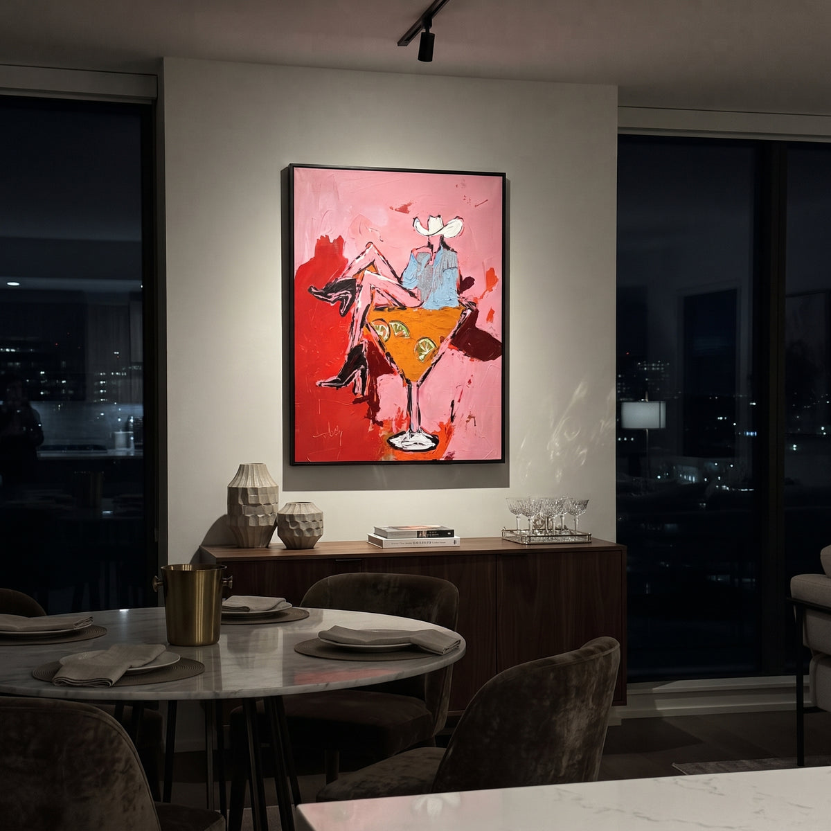 Western Cocktail Bar Cart is written from the actual artwork image, focusing on two cowgirls seated around a giant orange cocktail glass on a pink field. The composition is built from specific visible details: two white hats, orange cocktail glass, red boots, pink field, and bar-cart party composition. The vertical composition keeps attention on two white hats, orange cocktail glass, red boots, pink field, and bar-cart party composition, using open ground, cropped edges, and strong color blocks