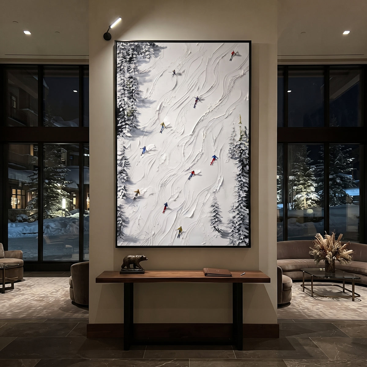 Silver Mountain Run focuses on a calm mountain basin with crisp tracks, snow shelves, and small skiers. The artwork shows a winter ski scene built from the actual image: visible downhill figures, curved snow tracks, raised ridgelines, and alpine space arranged in a tall composition. The white, gray, blue palette gives the piece a cold mountain atmosphere while the thick impasto surface creates shadows along each snowbank, ski line, and textured ridge. This is presented as hand-painted textured