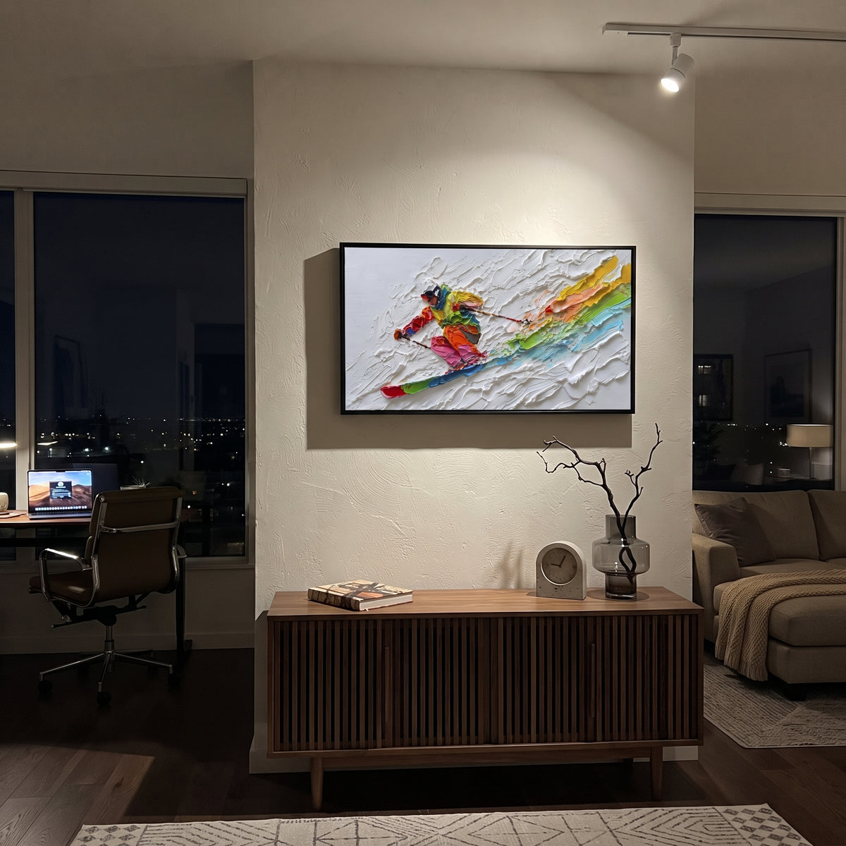 Rainbow Downhill Skier focuses on a close skier sweeping across thick white snow while rainbow bands trail behind the figure. The artwork shows a winter ski scene built from the actual image: visible downhill figures, curved snow tracks, raised ridgelines, and alpine space arranged in a wide composition. The white, green, red palette gives the piece a cold mountain atmosphere while the thick impasto surface creates shadows along each snowbank, ski line, and textured ridge. This is presented as