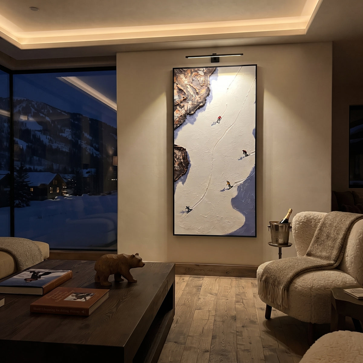 Summit Ski Valley With Pine Shadows focuses on soft gray snowfields broken by colorful skiers and thick ridge texture. The artwork shows a winter ski scene built from the actual image: visible downhill figures, curved snow tracks, raised ridgelines, and alpine space arranged in a tall composition. The white, gray, blue palette gives the piece a cold mountain atmosphere while the thick impasto surface creates shadows along each snowbank, ski line, and textured ridge. This is presented as