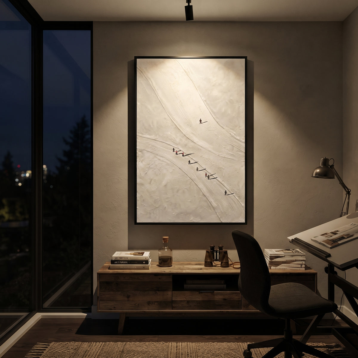 Carved Snow Trail With Pine Shadows focuses on soft gray snowfields broken by colorful skiers and thick ridge texture. The artwork shows a winter ski scene built from the actual image: visible downhill figures, curved snow tracks, raised ridgelines, and alpine space arranged in a tall composition. The white, black, gray palette gives the piece a cold mountain atmosphere while the thick impasto surface creates shadows along each snowbank, ski line, and textured ridge. This is presented as