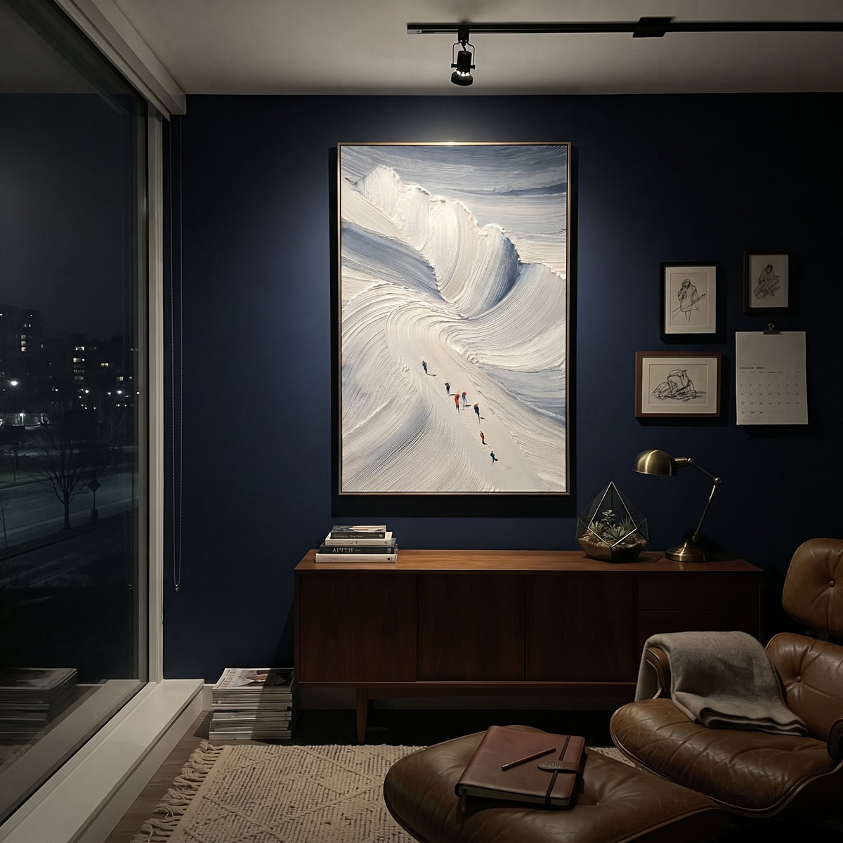 Blue Bowl Ski Descent focuses on small skiers moving below a deep blue bowl of thick sweeping snow texture. The artwork shows a winter ski scene built from the actual image: visible downhill figures, curved snow tracks, raised ridgelines, and alpine space arranged in a tall composition. The blue, white, gray palette gives the piece a cold mountain atmosphere while the thick impasto surface creates shadows along each snowbank, ski line, and textured ridge. This is presented as hand-painted