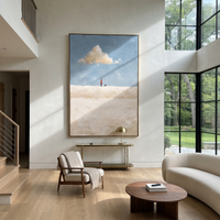 This 100% hand-painted abstract artwork features this hand-painted vertical canvas presents a minimalist scene with a tiny walking figure, pale blue sky, single cream cloud, and sculptural white plaster texture. Layered brushwork, tactile surface detail, and a refined framed presentation create a distinctive statement for living rooms, bedrooms, offices, entries, and modern commercial interiors.