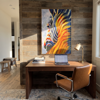 This 100% hand-painted western animal artwork features this hand-painted vertical canvas presents a close-up zebra portrait with bold black-and-white facial stripes and a dramatic mane of orange, yellow, red, blue, and deep green strokes. The graphic animal subject and expressive color movement create a striking contemporary focal point for living rooms, offices, hallways, bedrooms, and eclectic modern interiors.