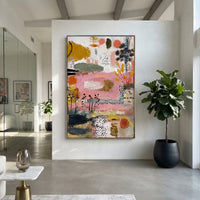 "Pink Botanical Bohemian Painting" focuses on atmosphere, surface movement, and sculptural heavy impasto craftsmanship rather than a fixed literal storyline. The composition uses this hand-painted vertical canvas presents a soft pink bohemian botanical abstract with black seed-like stems, ochre leaf forms, olive green bands, coral circles, dotted texture, and raised plaster-like brushwork as the visual anchor, while layered palette-knife paint, raised plaster-like texture, and softened brush