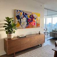 "Panoramic Bohemian Impasto Blocks Painting" focuses on atmosphere, surface movement, and sculptural heavy impasto craftsmanship rather than a fixed literal storyline. The composition uses this hand-painted panoramic canvas presents a wide bohemian impasto abstraction with yellow and cream blocks, deep navy contrasts, magenta and coral accents, grey passages, and sculptural palette-knife layers as the visual anchor, while layered palette-knife paint, raised plaster-like texture, and softened