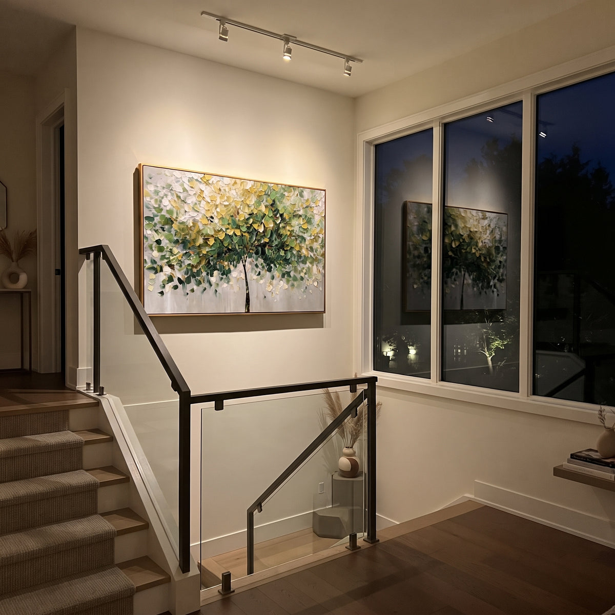 "Soft Green Canopy Tree Painting" focuses on atmosphere, surface movement, and sculptural heavy impasto craftsmanship rather than a fixed literal storyline. The composition uses this hand-painted panoramic canvas shows a graceful tree canopy spreading across a soft grey ground, with layered green, yellow, and white leaves, fine dark stems, and heavy palette-knife texture across the foliage as the visual anchor, while layered palette-knife paint, raised plaster-like texture, and softened brush