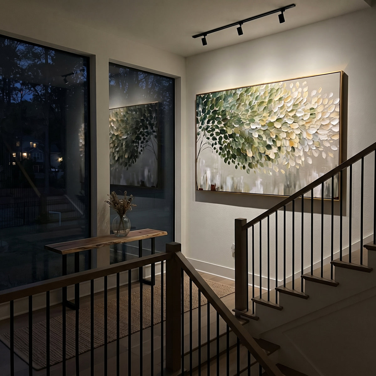 "Light Green Leaf Cluster Painting" focuses on atmosphere, surface movement, and sculptural heavy impasto craftsmanship rather than a fixed literal storyline. The composition uses this hand-painted horizontal canvas features a dense branch of rounded leaves, moving from dark green on the left to soft green, cream, and white on the right, with visible thick paint and a clean neutral lower field as the visual anchor, while layered palette-knife paint, raised plaster-like texture, and softened