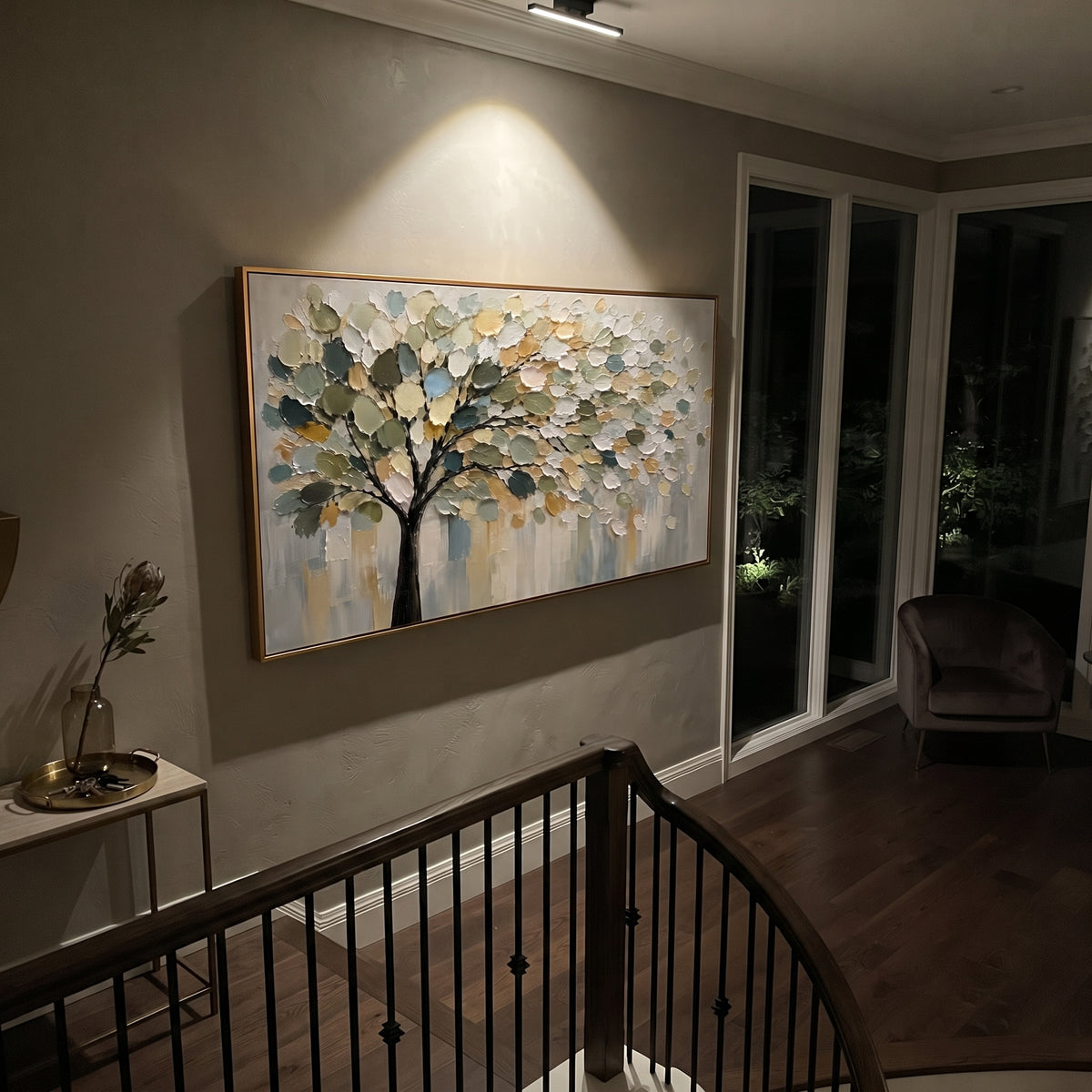 "Cream Gold Tree Canopy Painting" focuses on atmosphere, surface movement, and sculptural heavy impasto craftsmanship rather than a fixed literal storyline. The composition uses this hand-painted panoramic canvas features a soft tree canopy with deep green shadows, cream and golden leaves, fine black branches, a muted grey background, and thick raised palette-knife texture as the visual anchor, while layered palette-knife paint, raised plaster-like texture, and softened brush movement create