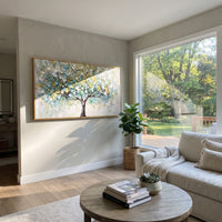 "Neutral Autumn Tree Painting" focuses on atmosphere, surface movement, and sculptural heavy impasto craftsmanship rather than a fixed literal storyline. The composition uses this hand-painted panoramic canvas shows a black-trunk tree with a wide canopy of muted sage, cream, white, and soft ochre leaves, set over a calm neutral background with heavy impasto texture as the visual anchor, while layered palette-knife paint, raised plaster-like texture, and softened brush movement create tactile