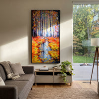 "Autumn Forest Reflection Painting" focuses on atmosphere, surface movement, and sculptural heavy impasto craftsmanship rather than a fixed literal storyline. The composition uses this hand-painted vertical canvas presents pale blue forest trunks above a narrow water reflection, framed by orange and yellow autumn leaves with thick palette-knife texture as the visual anchor, while layered palette-knife paint, raised plaster-like texture, and softened brush movement create tactile depth across the