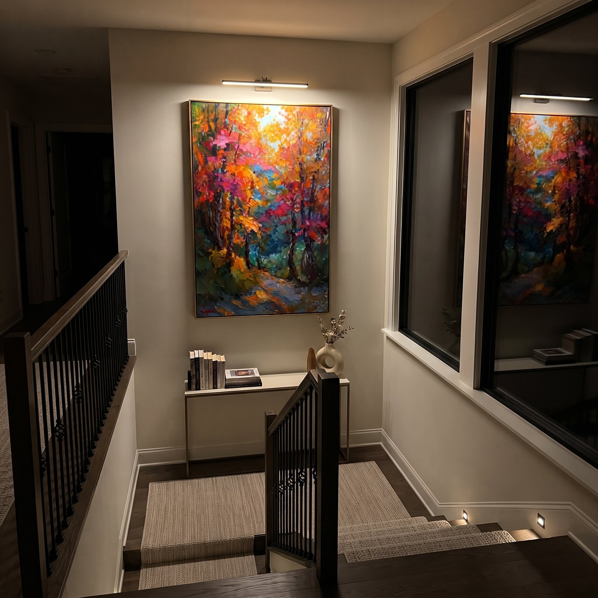 "Colorful Autumn Trail Painting" focuses on atmosphere, surface movement, and sculptural heavy impasto craftsmanship rather than a fixed literal storyline. The composition uses this hand-painted vertical canvas presents a vertical forest trail filled with orange, pink, teal, and green foliage, dark tree trunks, and energetic raised palette-knife texture as the visual anchor, while layered palette-knife paint, raised plaster-like texture, and softened brush movement create tactile depth across