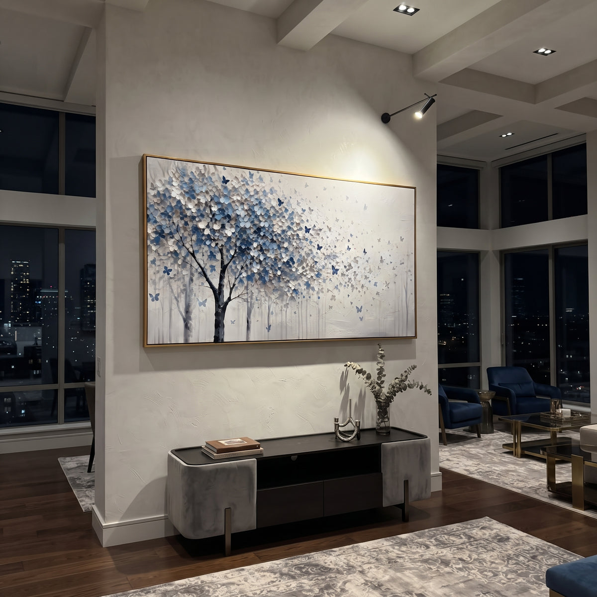 "Blue Butterfly Tree Painting" focuses on atmosphere, surface movement, and sculptural heavy impasto craftsmanship rather than a fixed literal storyline. The composition uses this hand-painted panoramic canvas presents a blue grey and white blossoming tree on the left with small blue butterflies drifting into an open white textured field as the visual anchor, while layered palette-knife paint, raised plaster-like texture, and softened brush movement create tactile depth across the canvas.