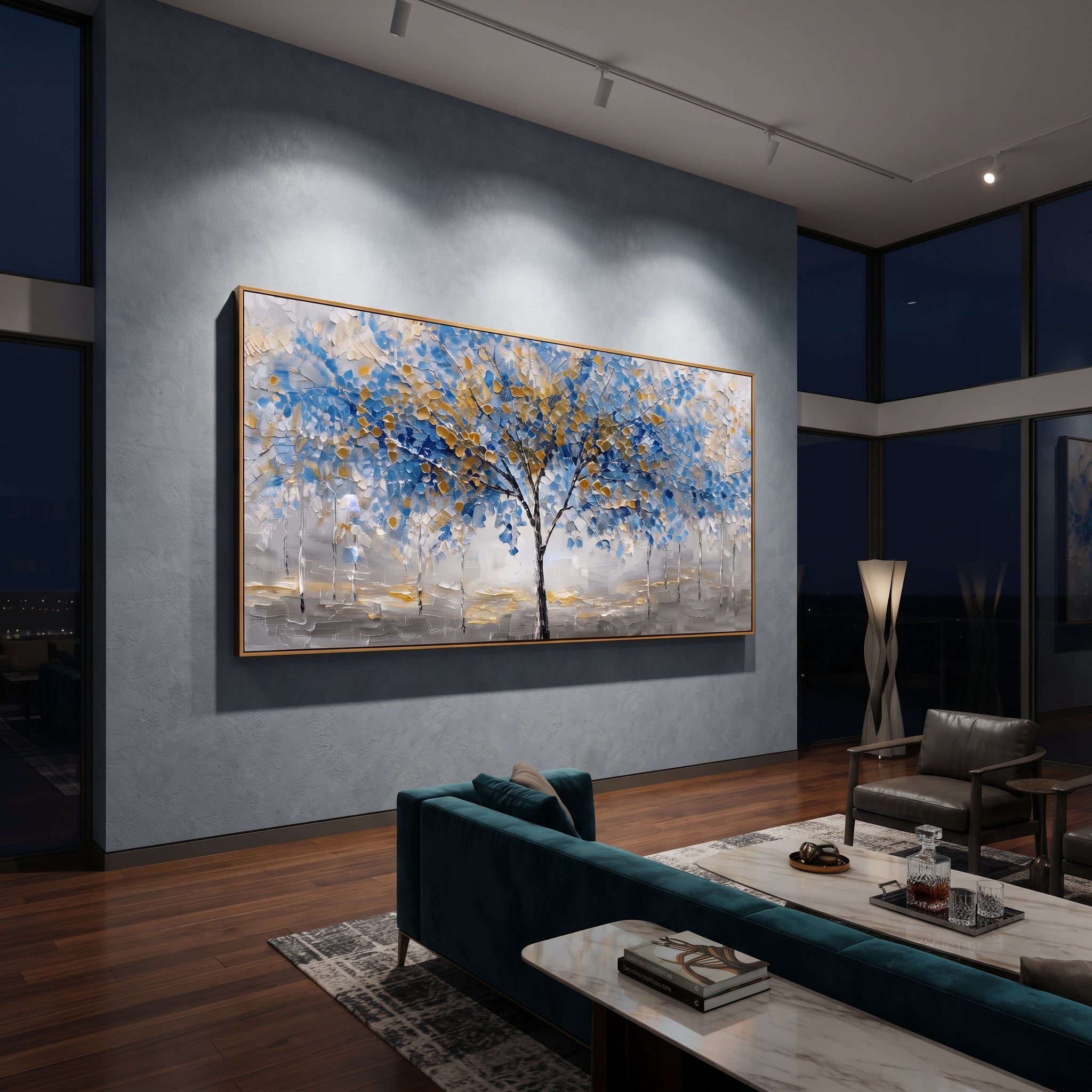 "Blue Gold Tree Painting" focuses on atmosphere, surface movement, and sculptural heavy impasto craftsmanship rather than a fixed literal storyline. The composition uses this hand-painted panoramic canvas presents a central black tree with blue and golden leaves over a grey white textured ground, with slender pale trees in the background as the visual anchor, while layered palette-knife paint, raised plaster-like texture, and softened brush movement create tactile depth across the canvas.