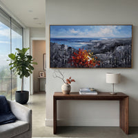 "Blue Coast Autumn Painting" focuses on atmosphere, surface movement, and sculptural heavy impasto craftsmanship rather than a fixed literal storyline. The composition uses this hand-painted panoramic canvas shows an open blue shoreline and grey rocky headlands, anchored by a thick red orange autumn tree and dark textured woodland in the foreground as the visual anchor, while layered palette-knife paint, raised plaster-like texture, and softened brush movement create tactile depth across the