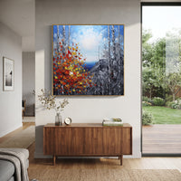 "Cliffside Birch Autumn Painting" focuses on atmosphere, surface movement, and sculptural heavy impasto craftsmanship rather than a fixed literal storyline. The composition uses this hand-painted square canvas looks through birch trunks to a blue water horizon and grey cliffs, with red, orange, and yellow leaves rising in thick strokes from the lower left as the visual anchor, while layered palette-knife paint, raised plaster-like texture, and softened brush movement create tactile depth across