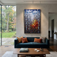 "Deep Blue Birch Leaves Painting" focuses on atmosphere, surface movement, and sculptural heavy impasto craftsmanship rather than a fixed literal storyline. The composition uses this hand-painted vertical canvas features a dark blue grey birch forest with tall white trunks and a rich red, orange, and yellow leaf cluster glowing from the lower right as the visual anchor, while layered palette-knife paint, raised plaster-like texture, and softened brush movement create tactile depth across the