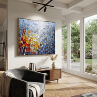 "Mountain Cove Birch Painting" focuses on atmosphere, surface movement, and sculptural heavy impasto craftsmanship rather than a fixed literal storyline. The composition uses this hand-painted horizontal canvas looks past grey birches and dark rocky slopes to a quiet blue cove, with red, orange, and yellow leaves clustered in the foreground as the visual anchor, while layered palette-knife paint, raised plaster-like texture, and softened brush movement create tactile depth across the canvas.