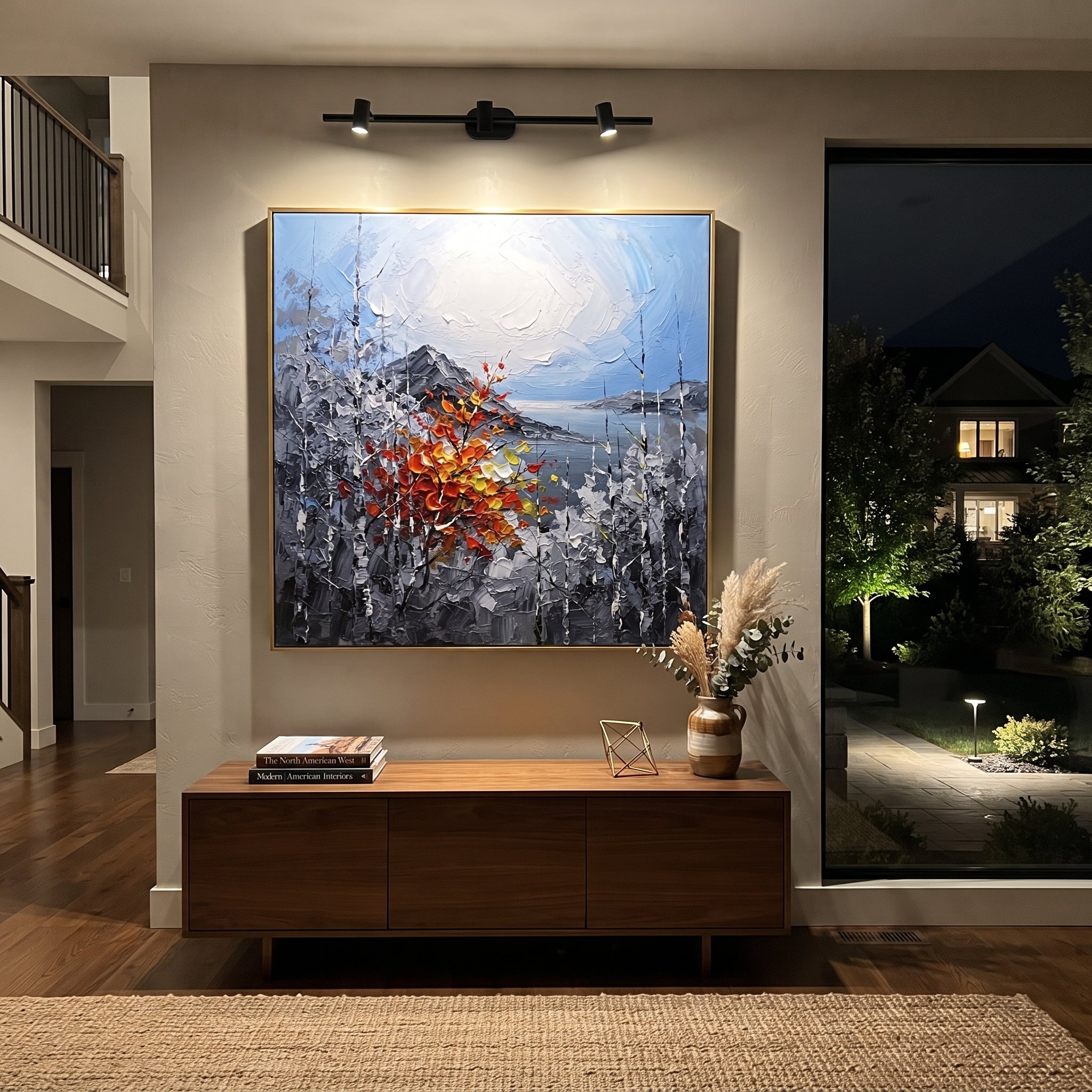 "Silver Birch Autumn Branch Painting" focuses on atmosphere, surface movement, and sculptural heavy impasto craftsmanship rather than a fixed literal storyline. The composition uses this hand-painted square canvas features cool grey birch trunks around a pale blue white sky, with one red orange yellow branch rising through the center in raised palette-knife texture as the visual anchor, while layered palette-knife paint, raised plaster-like texture, and softened brush movement create tactile