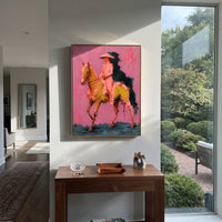 "Side Riding Cowboy Horse Painting" focuses on atmosphere, surface movement, and sculptural heavy impasto craftsmanship rather than a fixed literal storyline. The composition uses this hand-painted vertical canvas shows a cowboy riding in profile on a golden brown horse across a rose pink background as the visual anchor, while layered palette-knife paint, raised plaster-like texture, and softened brush movement create tactile depth across the canvas. Curated with a balanced pink, brown, green