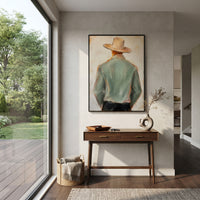 "Side Turn Sage Cowboy Painting" focuses on atmosphere, surface movement, and sculptural heavy impasto craftsmanship rather than a fixed literal storyline. The composition uses this hand-painted vertical canvas shows a side-turned cowboy in a pale green jacket and wide beige hat, with black trousers and warm brown face tones as the visual anchor, while layered palette-knife paint, raised plaster-like texture, and softened brush movement create tactile depth across the canvas. Curated with a