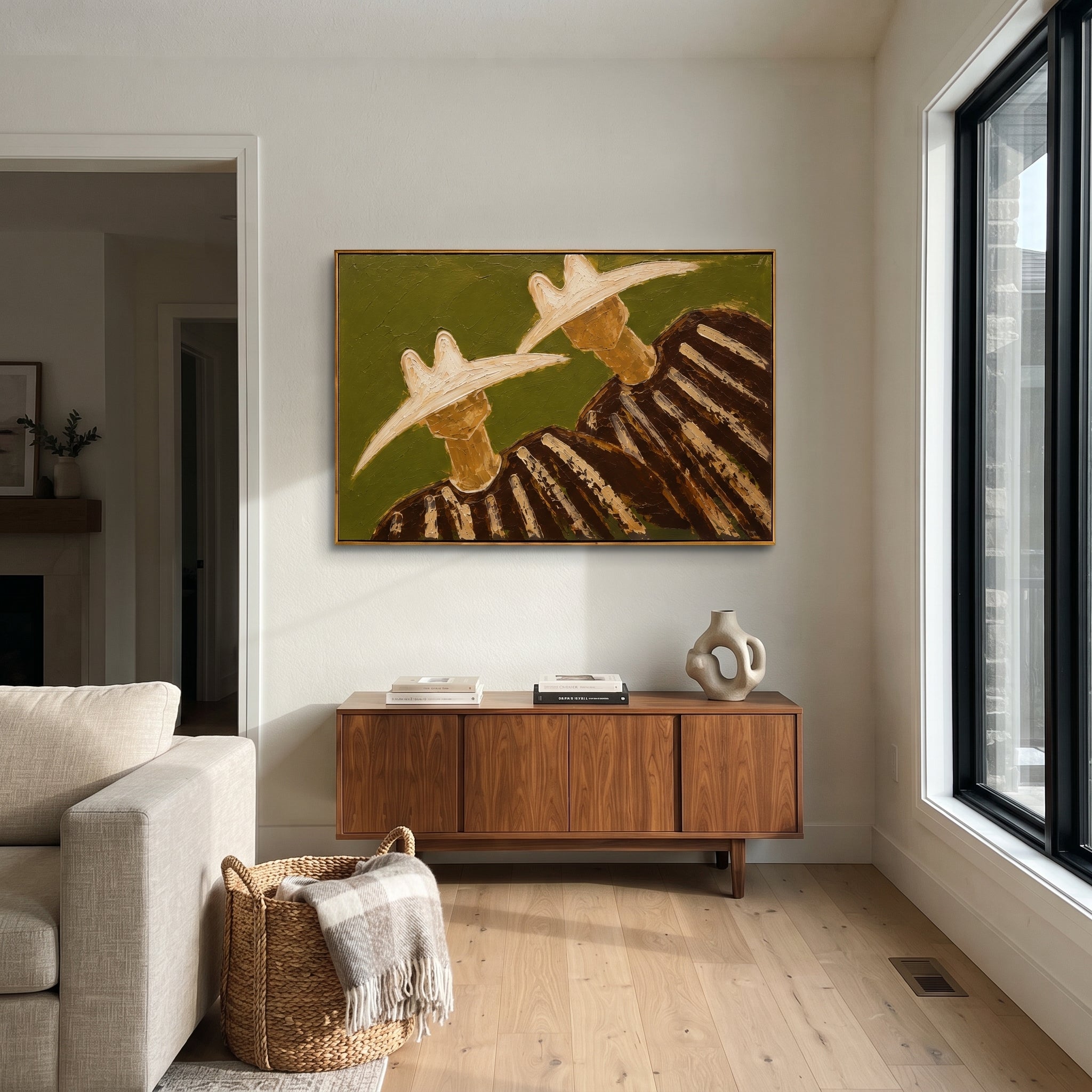 "Side By Side Cowboy Duo Painting" focuses on atmosphere, surface movement, and sculptural heavy impasto craftsmanship rather than a fixed literal storyline. The composition uses this hand-painted horizontal canvas shows two cowboys standing side by side with large pale hats, dark shadowed faces, and brown striped garments as the visual anchor, while layered palette-knife paint, raised plaster-like texture, and softened brush movement create tactile depth across the canvas. Curated with a