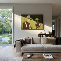 "Separated Cowboy Duo Painting" focuses on atmosphere, surface movement, and sculptural heavy impasto craftsmanship rather than a fixed literal storyline. The composition uses this hand-painted horizontal canvas places two cowboys apart on an olive green plaster field, each wearing a broad cream hat and dark brown western jacket as the visual anchor, while layered palette-knife paint, raised plaster-like texture, and softened brush movement create tactile depth across the canvas. Curated with a