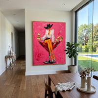 "Cowgirl Martini Glass Painting" focuses on atmosphere, surface movement, and sculptural heavy impasto craftsmanship rather than a fixed literal storyline. The composition uses this hand-painted vertical canvas features a stylish cowgirl sitting on the rim of a red martini glass against a vivid pink plaster background as the visual anchor, while layered palette-knife paint, raised plaster-like texture, and softened brush movement create tactile depth across the canvas. Curated with a balanced