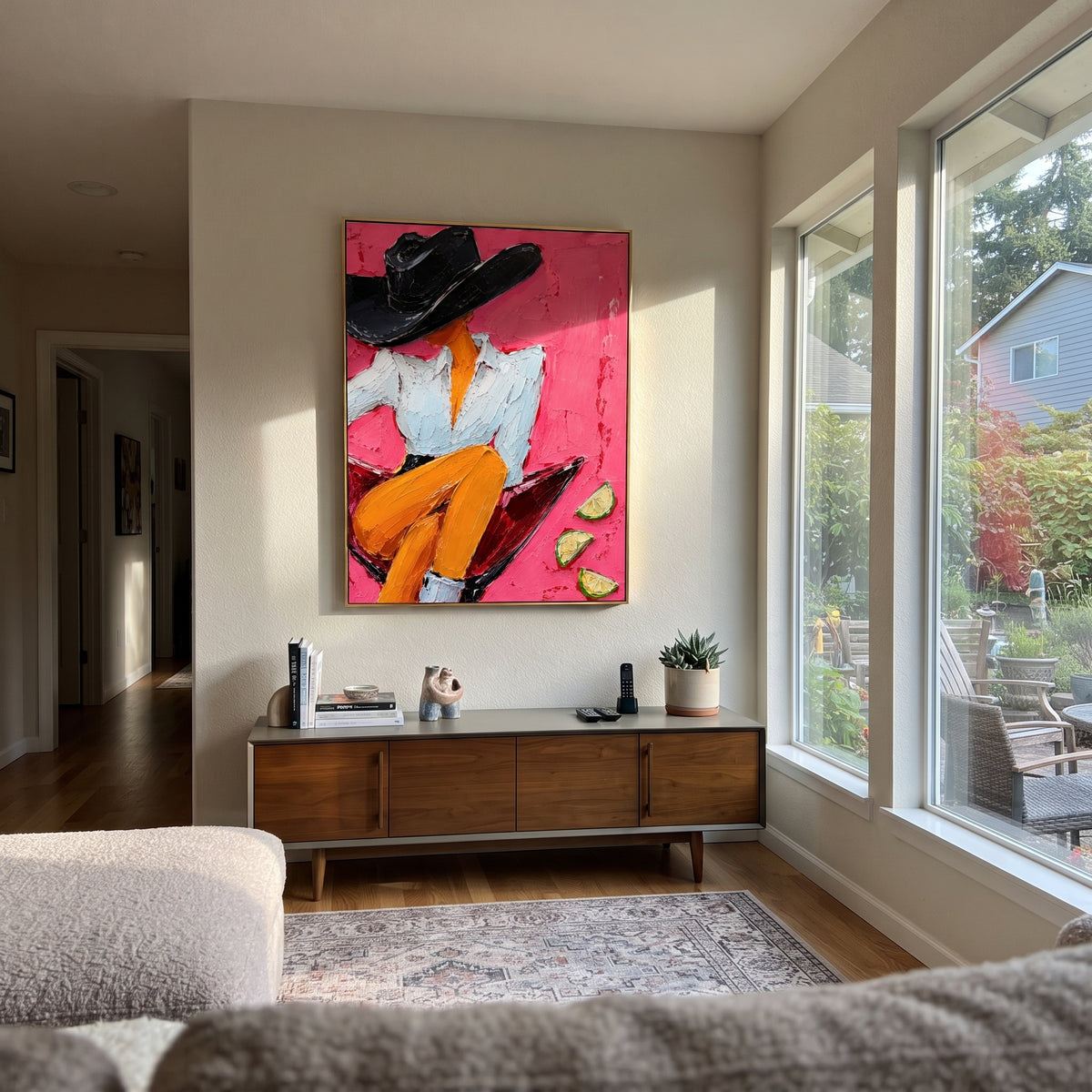 "Side Sitting Martini Cowgirl Painting" focuses on atmosphere, surface movement, and sculptural heavy impasto craftsmanship rather than a fixed literal storyline. The composition uses this hand-painted vertical canvas presents a side-profile cowgirl perched on the rim of a red martini glass as the visual anchor, while layered palette-knife paint, raised plaster-like texture, and softened brush movement create tactile depth across the canvas. Curated with a balanced pink, orange, black palette