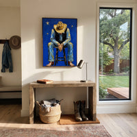 "Bowed Hat Blue Cowboy Painting" focuses on atmosphere, surface movement, and sculptural heavy impasto craftsmanship rather than a fixed literal storyline. The composition uses this hand-painted vertical canvas depicts a cowboy sitting forward on a stool, head lowered beneath a tan hat and hands resting between blue denim legs as the visual anchor, while layered palette-knife paint, raised plaster-like texture, and softened brush movement create tactile depth across the canvas. Curated with a