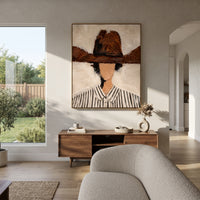 "Wide Brown Hat Portrait Painting" focuses on atmosphere, surface movement, and sculptural heavy impasto craftsmanship rather than a fixed literal storyline. The composition uses this hand-painted vertical canvas features a faceless figure in a wide brown hat and black-striped white shirt against a creamy plaster background as the visual anchor, while layered palette-knife paint, raised plaster-like texture, and softened brush movement create tactile depth across the canvas. Curated with a