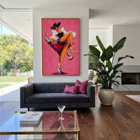 "Black Corset Martini Cowgirl Painting" focuses on atmosphere, surface movement, and sculptural heavy impasto craftsmanship rather than a fixed literal storyline. The composition uses this hand-painted vertical canvas features a cowgirl in a black hat and black corset lounging inside a red martini glass against a bright pink plaster background as the visual anchor, while layered palette-knife paint, raised plaster-like texture, and softened brush movement create tactile depth across the canvas.