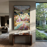 "Mountain Bay Village PT 1575" focuses on atmosphere, surface movement, and sculptural heavy impasto craftsmanship rather than a fixed literal storyline. The composition uses this hand-painted Mediterranean canvas features coastal mountains, small village rooftops, winding shore, blue bay and garden accents, built with raised palette-knife texture, layered brushwork, and luminous coastal color as the visual anchor, while layered palette-knife paint, raised plaster-like texture, and softened