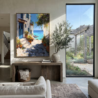 "White Alley Bougainvillea Painting" focuses on atmosphere, surface movement, and sculptural heavy impasto craftsmanship rather than a fixed literal storyline. The composition uses this hand-painted Mediterranean canvas features whitewashed stone lane, cascading pink bougainvillea, blue sea opening, sunlit village walls, built with raised palette-knife texture, layered brushwork, and luminous coastal color as the visual anchor, while layered palette-knife paint, raised plaster-like texture, and