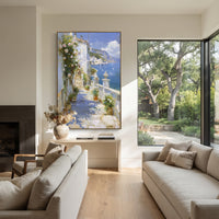 "Blue Bay Flower Garden Painting" focuses on atmosphere, surface movement, and sculptural heavy impasto craftsmanship rather than a fixed literal storyline. The composition uses this hand-painted Mediterranean canvas features sailboats on a blue bay, flowering terrace, coastal town and luminous summer sky, built with raised palette-knife texture, layered brushwork, and luminous coastal color as the visual anchor, while layered palette-knife paint, raised plaster-like texture, and softened brush